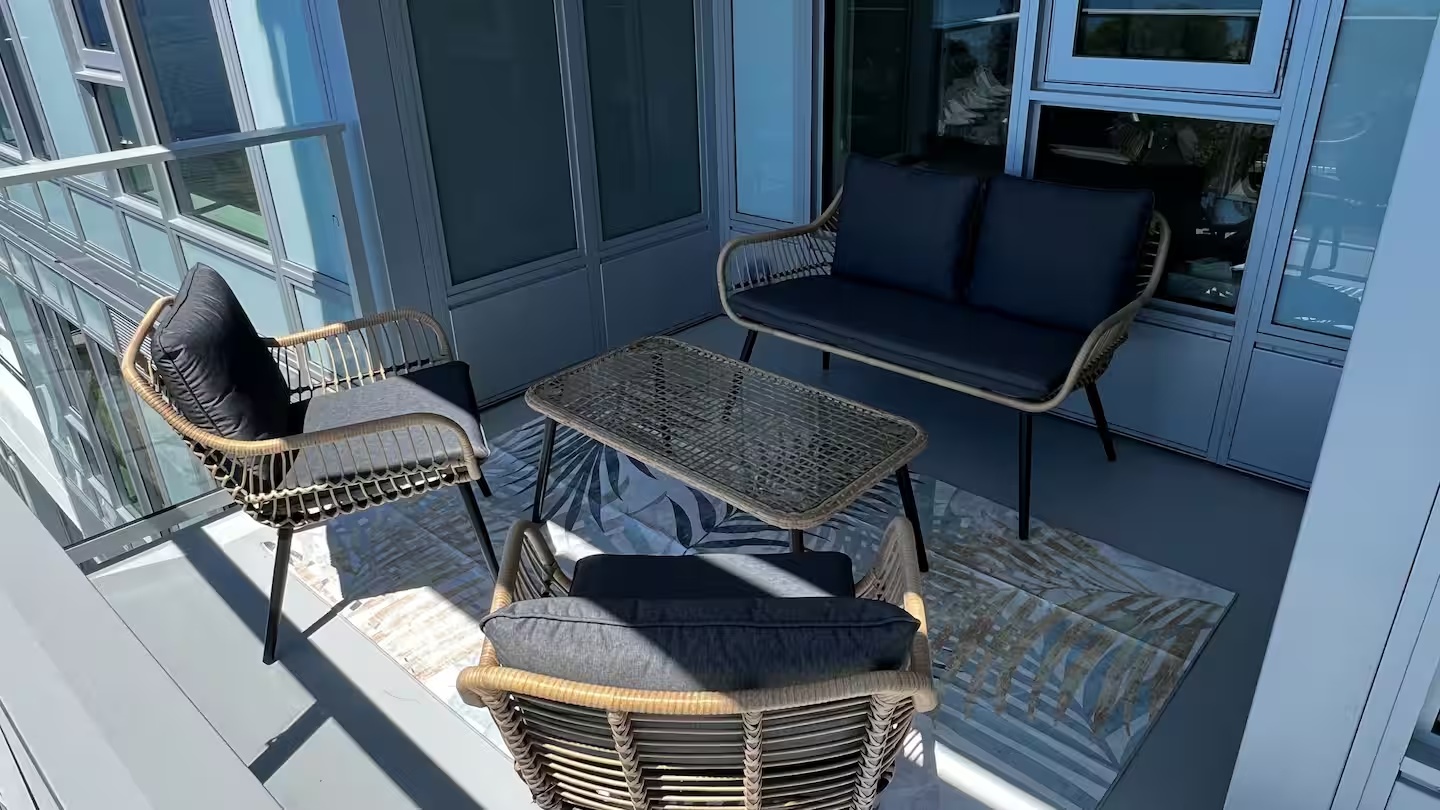 Private furnished balcony with seating for four