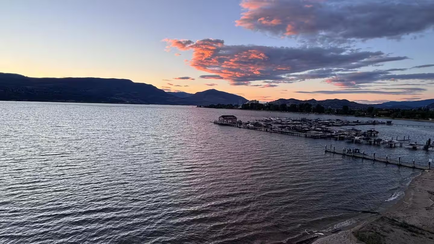 Marina and mountains at sunset beside Aqua